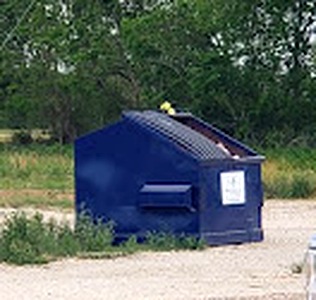 On-site trash dumpster at Angleton RV Park & Resort